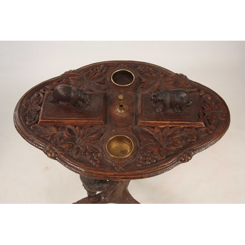 394 - A LATE 19TH CENTURY SWISS CARVED BLACK FOREST SMOKERS TABLE with leaf carved top having two bear lid... 