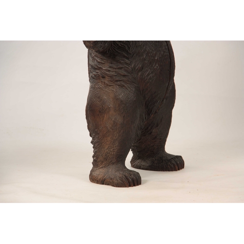 395 - AN INTERESTING PAIR OF LATE 19TH CENTURY SWISS CARVED BLACK FOREST STANDING BEARS with glass eyes 80... 