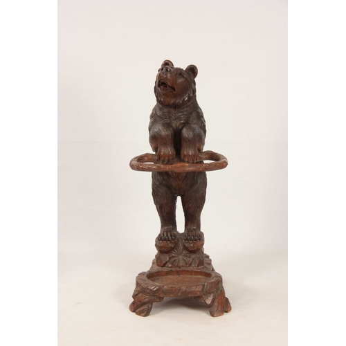 396 - A LATE 19TH CENTURY SWISS CARVED BLACK FOREST BEAR STICK STAND with a large bear having glass eyes h... 