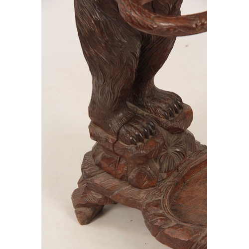 396 - A LATE 19TH CENTURY SWISS CARVED BLACK FOREST BEAR STICK STAND with a large bear having glass eyes h... 