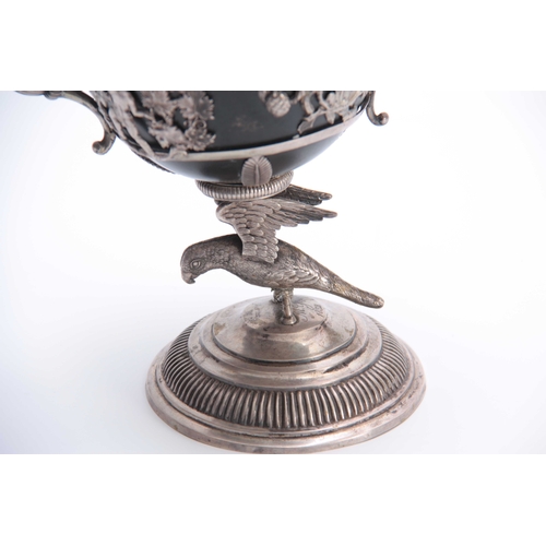 402 - A 19TH CENTURY SILVER METAL CHALICE with parrot cast base and flared foot 20cm