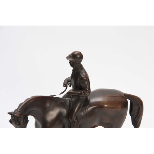 426 - A LATE 19th CENTURY PATINATED BRONZE SCULPTURE modelled as a jockey and horse on naturalistic base 2... 