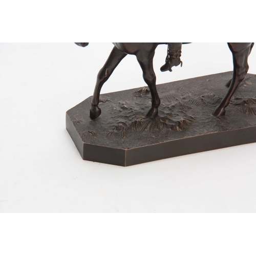 426 - A LATE 19th CENTURY PATINATED BRONZE SCULPTURE modelled as a jockey and horse on naturalistic base 2... 