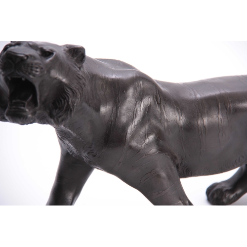 432 - A MEIJI PERIOD JAPANESE BRONZE TIGER - signed to the underside with character marks 56cm overall.