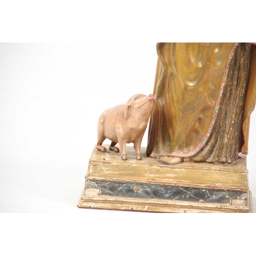 435 - A 19TH CENTURY CARVED WOOD POLYCHROME FIGURE OF SAINT ANTHONY on a rectangular plinth base 92cm high