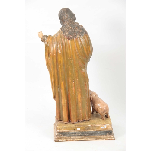 435 - A 19TH CENTURY CARVED WOOD POLYCHROME FIGURE OF SAINT ANTHONY on a rectangular plinth base 92cm high