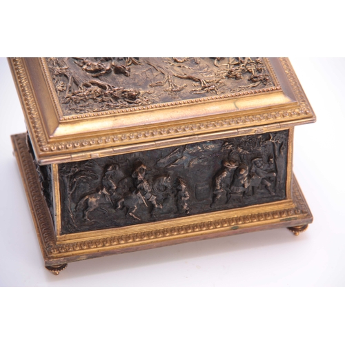 437 - A LATE 19TH CENTURY CONTINENTAL GILT BRASS JEWELLERY CASKET set with cast bronzed figural panels to ... 