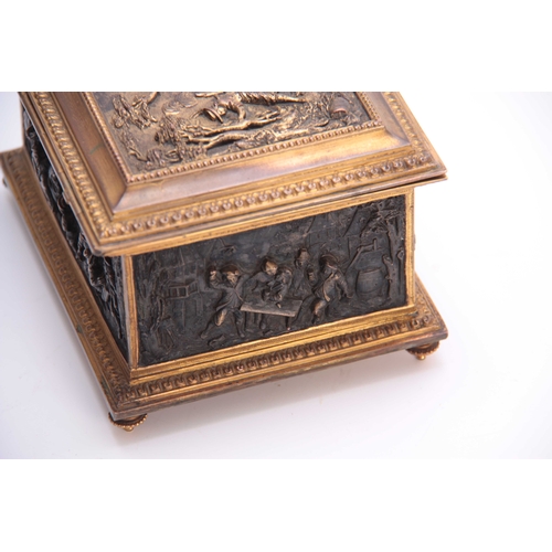 437 - A LATE 19TH CENTURY CONTINENTAL GILT BRASS JEWELLERY CASKET set with cast bronzed figural panels to ... 