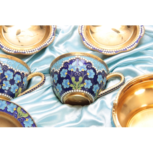 448 - A 20TH CENTURY CASED RUSSIAN SILVER GILT AND ENAMEL TEA SERVICE comprising of a large bowl, six cups... 