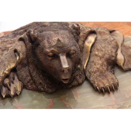 454 - OF RUSSIAN INTEREST, A 19TH CENTURY GILT BRONZE INKWELL OF A FOLDED BEAR RUG mounted on an onyx marb... 