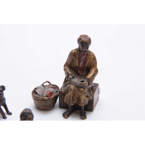 466 - A COLLECTION OF THREE EARLY 20th CENTURY COLD PAINTED BRONZE FIGURES modelled as an Arab bookseller,... 