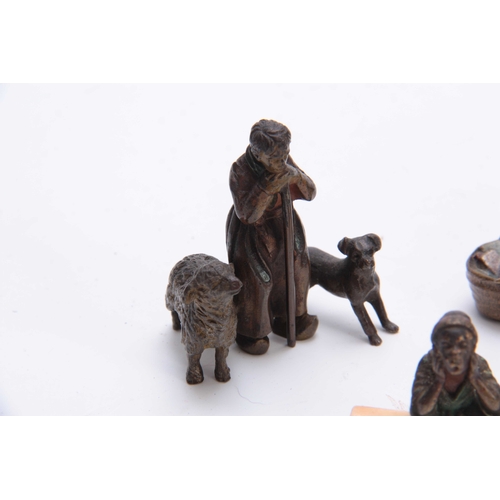 466 - A COLLECTION OF THREE EARLY 20th CENTURY COLD PAINTED BRONZE FIGURES modelled as an Arab bookseller,... 