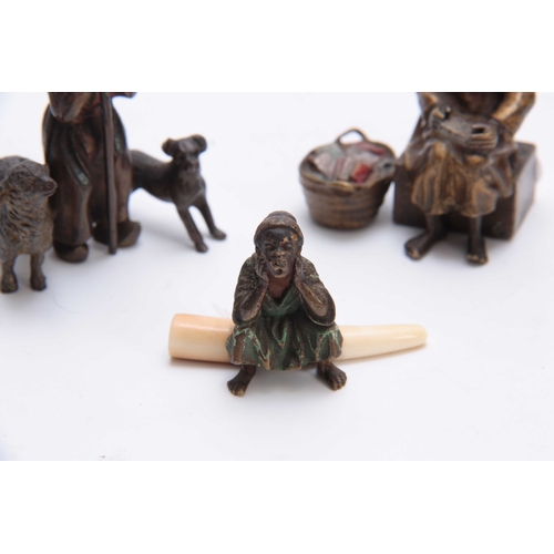 466 - A COLLECTION OF THREE EARLY 20th CENTURY COLD PAINTED BRONZE FIGURES modelled as an Arab bookseller,... 