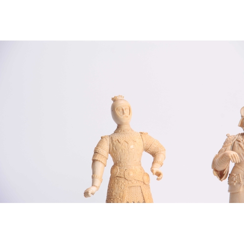 483 - A PAIR OF 19th CENTURY CARVED IVORY FIGURES modelled as knights in armour standing on turned ebonize... 