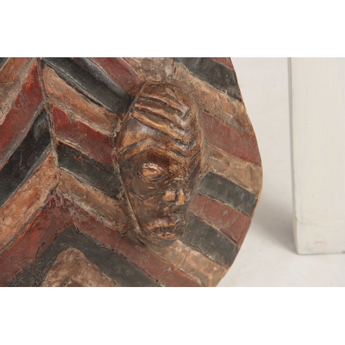 486 - AN AFRICAN PAINTED WOODEN TRIBAL CEREMONIAL SHIELD with four carved heads 76cm high