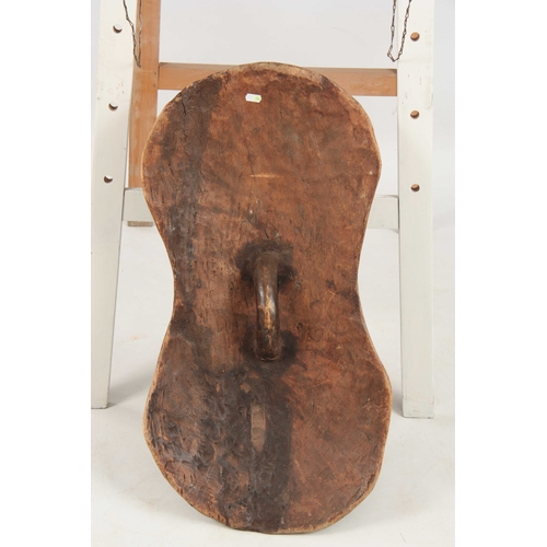 486 - AN AFRICAN PAINTED WOODEN TRIBAL CEREMONIAL SHIELD with four carved heads 76cm high