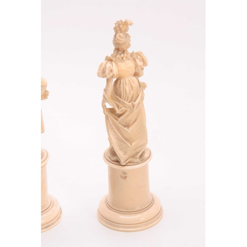 498 - A FINE PAIR OF 19TH CENTURY EUROPEAN CARVED IVORY FIGURES depicting a Lady and a Gentleman in fine d... 