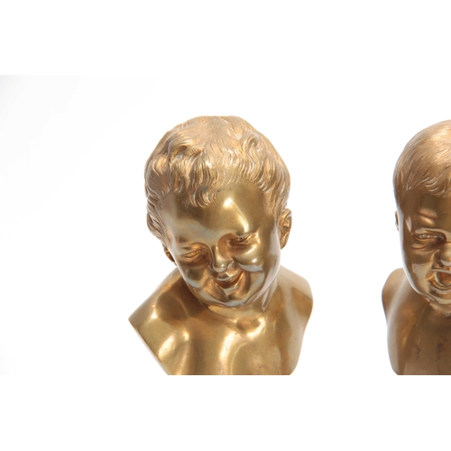 511 - A PAIR OF LATE 19TH CENTURY GILT BRONZE BUSTS OF GIRL AND BOY mounted on veined red marble socles 22... 