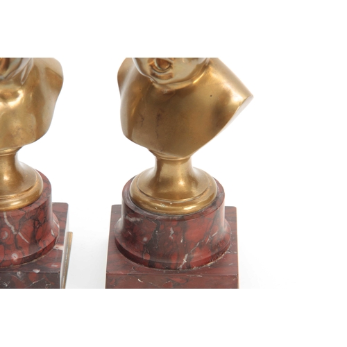 511 - A PAIR OF LATE 19TH CENTURY GILT BRONZE BUSTS OF GIRL AND BOY mounted on veined red marble socles 22... 