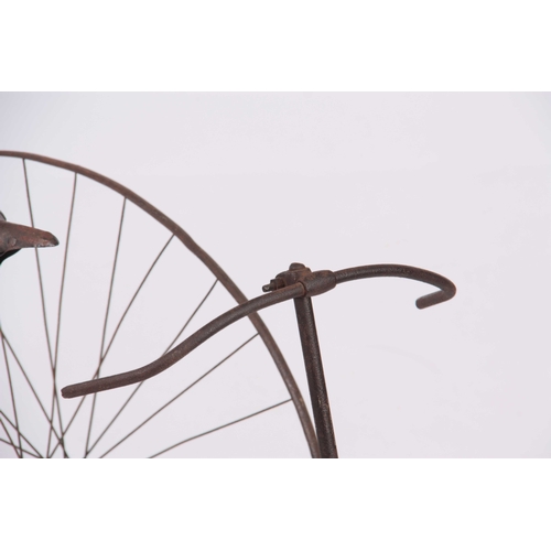 514 - AN UNUSUAL 19th CENTURY CHILDS TRICYCLE having an iron frame and spoked wheels with chain drive 1200... 