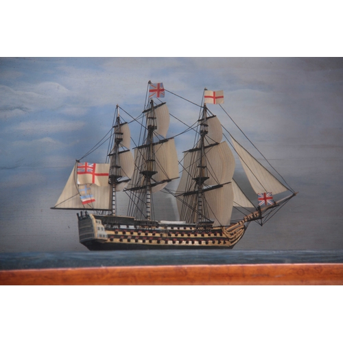 527 - A 19TH CENTURY DIORAMA MODEL OF A GUNSHIP mounted in a glazed birds-eye maple frame 40cm wide 26cm h... 