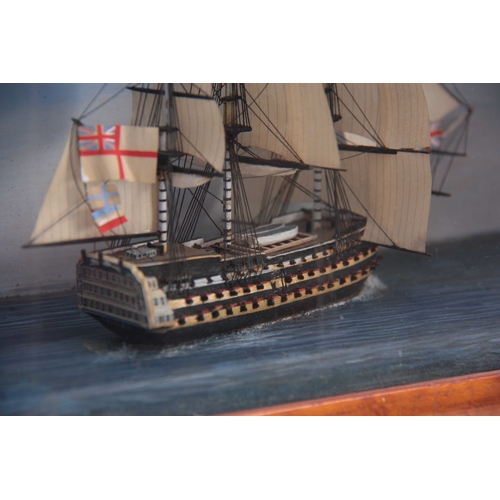 527 - A 19TH CENTURY DIORAMA MODEL OF A GUNSHIP mounted in a glazed birds-eye maple frame 40cm wide 26cm h... 