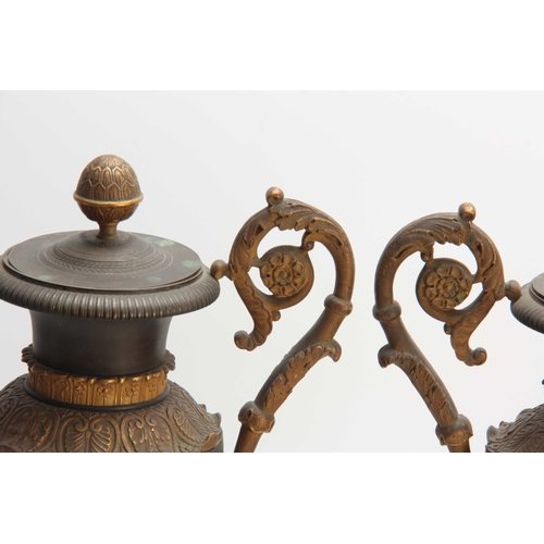 529 - A PAIR OF REGENCY BRONZE AND ORMOLU ADAM STYLE URNS / CANDLEHOLDERS having reversible tops and scrol... 