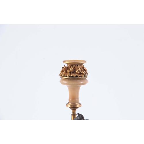 549 - A PAIR OF 19TH CENTURY FRENCH BRONZE, ORMOLU AND MARBLE CANDLESTICKS with square bases and winged ea... 