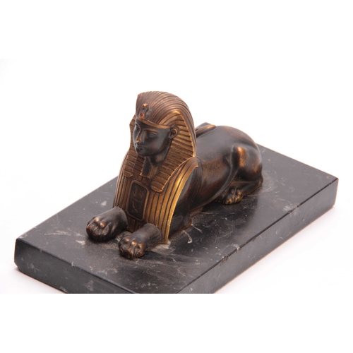 550 - A PAIR OF LATE 19TH CENTURY REGENCY STYLE BRONZE AND GILT BRONZE SPHINX BOOKENDS mounted on black ma... 