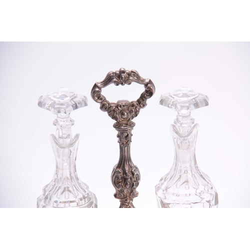 566 - A 19TH CENTURY FRENCH HALLMARKED SILVER TABLE SET in the rococo taste having cut glass bottles