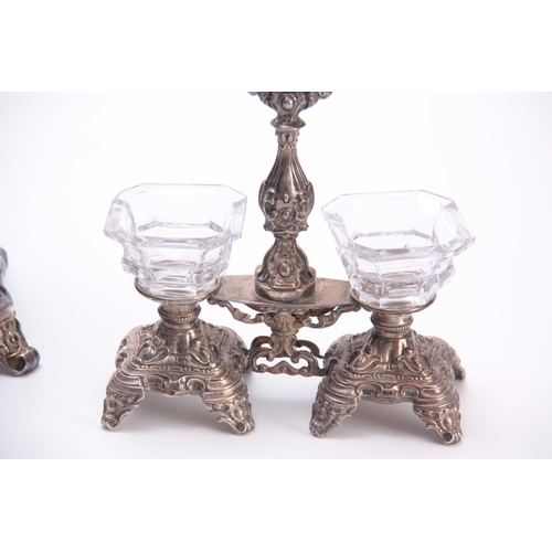 566 - A 19TH CENTURY FRENCH HALLMARKED SILVER TABLE SET in the rococo taste having cut glass bottles