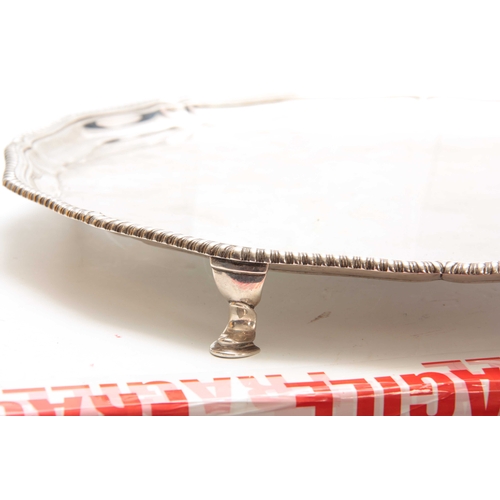 573 - A LARGE LATE 19th CENTURY SILVER SALVER with pie crust edge supported on four cabriolet feet 45cm di... 