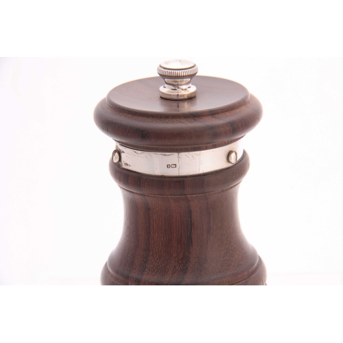 585 - A LATE 19TH CENTURY TURNED WOOD AND SILVER MOUNTED PEPPER MILL - Birmingham 1885 9cm high.