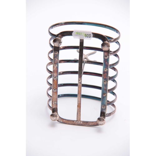 601 - A VICTORIAN SILVER TOAST RACK of six divisional hooped form with raised ring handle and facetted fee... 