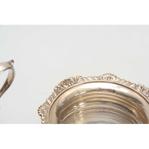 605 - A SELECTION OF SOLID SILVER ITEMS including two wine coasters, sauceboat, three napkin rings and a s... 