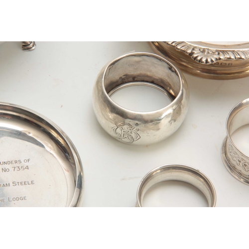 605 - A SELECTION OF SOLID SILVER ITEMS including two wine coasters, sauceboat, three napkin rings and a s... 