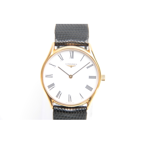 616 - A GENTLEMANS GOLDPLATED LONGINES WRIST WATCH on snakeskin leather strap, the goldplated case with st... 