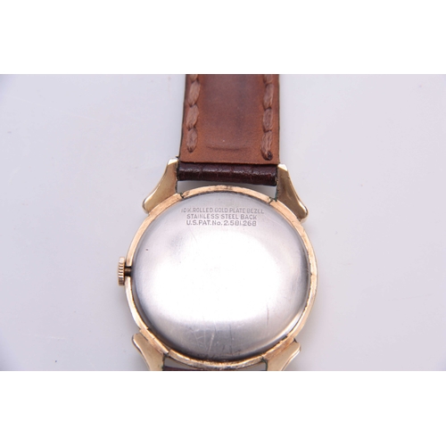 622 - A 1950's GENTLEMANS BENRUS DAY/DATE WRIST WATCH the gold plated case with ornate lugs enclosing a si... 