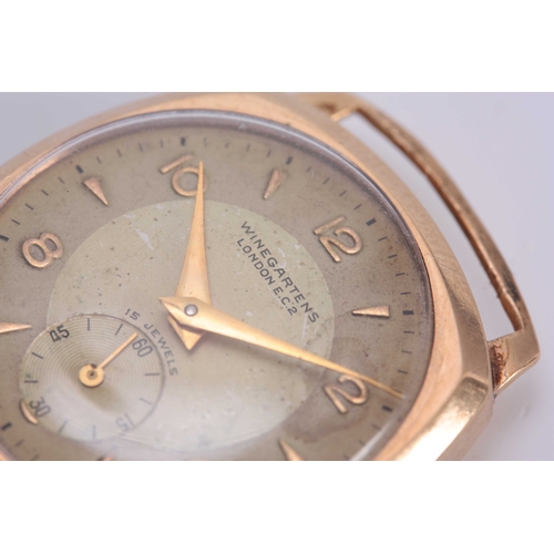 651 - WINEGARTENS, LONDON E.C. 2. A GENTLEMANS VINTAGE 9CT GOLD WRIST WATCH the tank shaped case enclosing... 