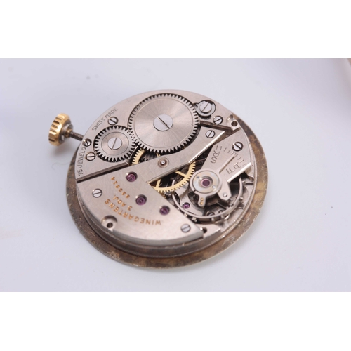 651 - WINEGARTENS, LONDON E.C. 2. A GENTLEMANS VINTAGE 9CT GOLD WRIST WATCH the tank shaped case enclosing... 