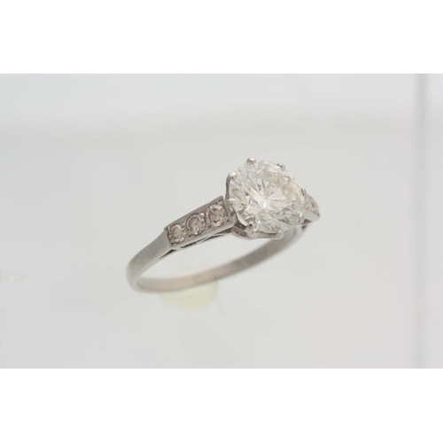 661 - A FINE 18CT WHITE GOLD BRILLIANT CUT SOLITAIRE DIAMOND RING claw set with small three stone tapering... 