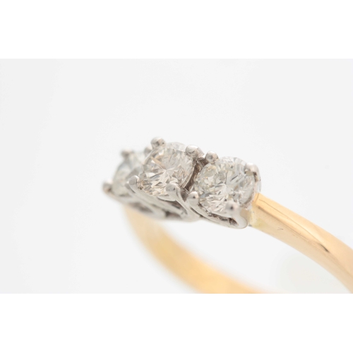 680 - A .750CT YELLOW GOLD STRAIGHT SET THREE STONE DIAMOND RING with flattened square shank