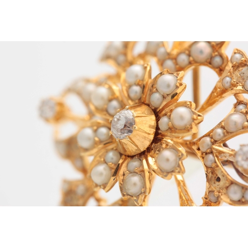 681 - A 15CT YELLOW GOLD DIAMOND SET AND SEED PEARL FLOWERHEAD BROOCH of openwork design with raised centr... 