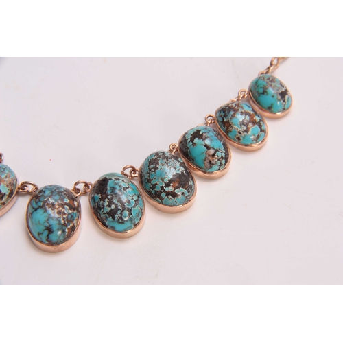 688 - A GOLD AND TURQUOISE NECKLACE having twelve oval-shaped turquoise pendants - 48cm long.