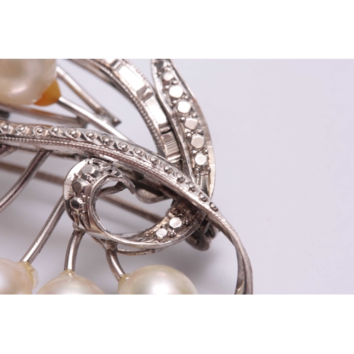 695 - A STYLISH 14CT WHITE GOLD AND PEARL SET BROOCH - hallmarked 14ct 5.5cm wide