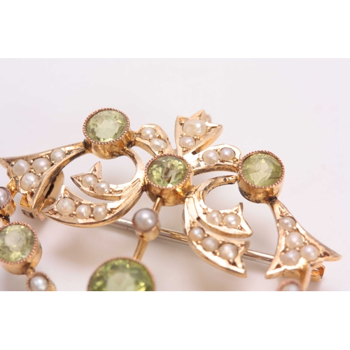 700 - A FINELY MADE 9CT GOLD PERIDOT AND PEARL SET BROOCH - hallmarked 9ct gold 3.5cm wide 4.5cm overall.