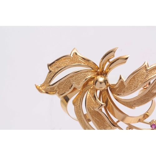 706 - AN 18CT GOLD AND RUBY SET BROOCH designed as leaves and berries - hallmarked 18ct 52mm wide.