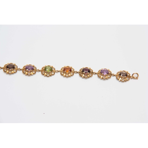 710 - A 9CT GOLD FILIGREE MULTI-COLOURED STONES BRACELET 17.5cm across