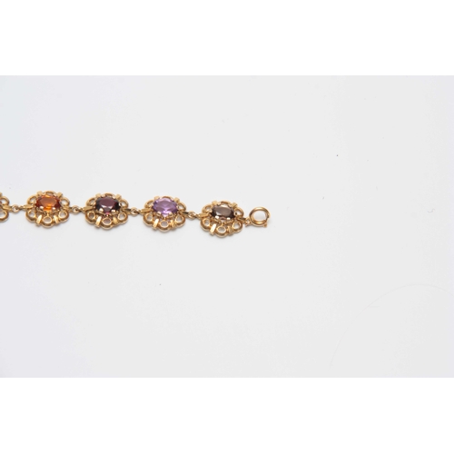 710 - A 9CT GOLD FILIGREE MULTI-COLOURED STONES BRACELET 17.5cm across