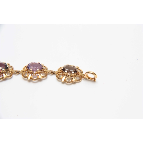 710 - A 9CT GOLD FILIGREE MULTI-COLOURED STONES BRACELET 17.5cm across